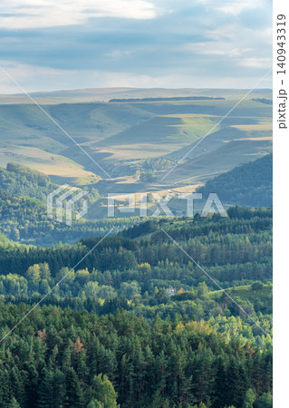 Layers of green mountains and hills in the haze during sunset. Panoramic View of Green hills and Meadow. Layers of green mountains and hills in the haze during sunset. Panoramic View of Green hills and Meadow. 140943319