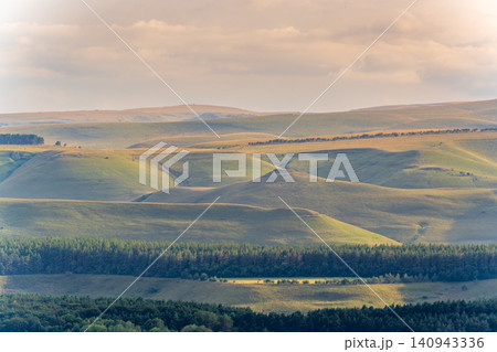 Layers of green mountains and hills in the haze during sunset. Panoramic View of Green hills and Meadow. 140943336