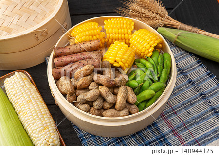 Boiled peanuts, corn cobs, Chinese yams and edamame pods in bamboo steamer Boiled peanuts, corn cobs, Chinese yams and edamame pods in bamboo steamer 140944125