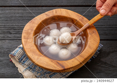 cooked sweet glutinous rice balls in clear soup, authentic hot Chinese Tangyuan mochi dessert cooked sweet glutinous rice balls in clear soup, authentic hot Chinese Tangyuan mochi dessert 140944627