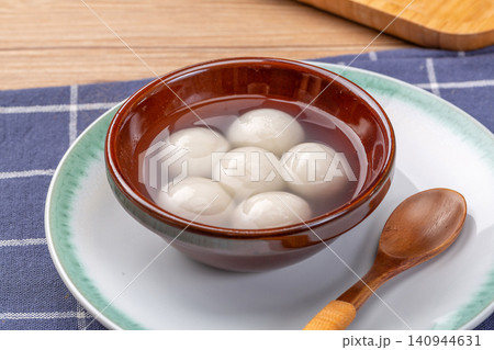 cooked sweet glutinous rice balls in clear soup, authentic hot Chinese Tangyuan mochi dessert cooked sweet glutinous rice balls in clear soup, authentic hot Chinese Tangyuan mochi dessert 140944631