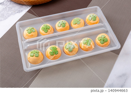 frozen raw persimmon shaped sweet rice balls, uncooked orange Tangyuan with black sesame filling for Chinese New Year frozen raw persimmon shaped sweet rice balls, uncooked orange Tangyuan with black sesame filling for Chinese New Year 140944663