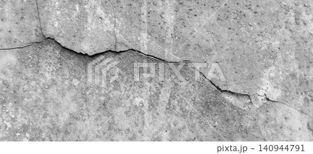The texture of a weathered concrete wall with large cracks. The texture of a weathered concrete wall with large cracks. 140944791