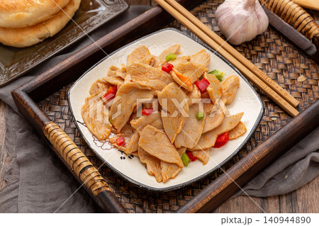 spicy Chinese cold salad with vegetarian chicken wings, savory seasoned soy protein slices with chili oil 140944890