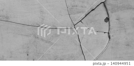 Abstract background with a cracked concrete wall texture in monochrome tones. Abstract background with a cracked concrete wall texture in monochrome tones. 140944951