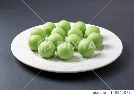 raw green glutinous rice dough balls, prepared mugwort infused dough spheres for making Qingtuan mochi raw green glutinous rice dough balls, prepared mugwort infused dough spheres for making Qingtuan mochi 140945078