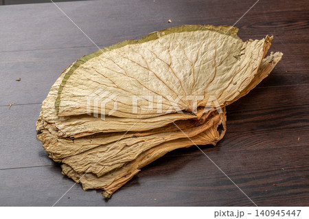 stack of dried lotus leaves used as a traditional wrapper for wrapping glutinous rice chicken. 140945447