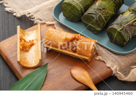 steamed sweet glutinous rice zongzi infused with candied honey dates and bamboo aroma. steamed sweet glutinous rice zongzi infused with candied honey dates and bamboo aroma. 140945460