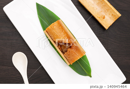 steamed sweet glutinous rice zongzi infused with candied honey dates and bamboo aroma. steamed sweet glutinous rice zongzi infused with candied honey dates and bamboo aroma. 140945464
