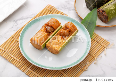 steamed sweet glutinous rice zongzi infused with candied honey dates and bamboo aroma. steamed sweet glutinous rice zongzi infused with candied honey dates and bamboo aroma. 140945465