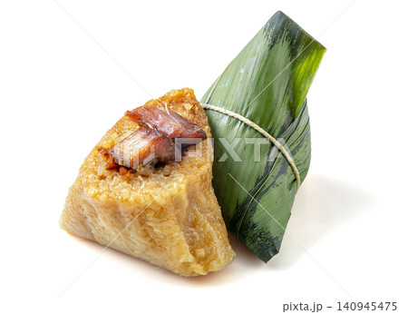 savory glutinous rice zongzi dumpling filled with marinated pork belly and wrapped in bamboo leaves. 140945475