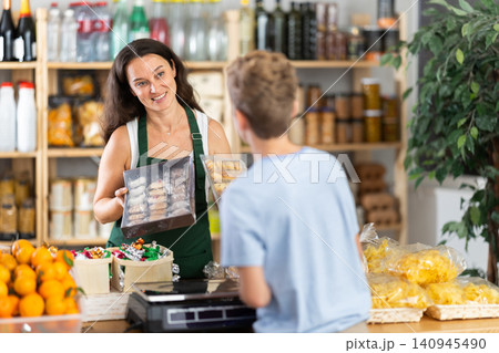 Female employee sells cookies to teen boy 140945490