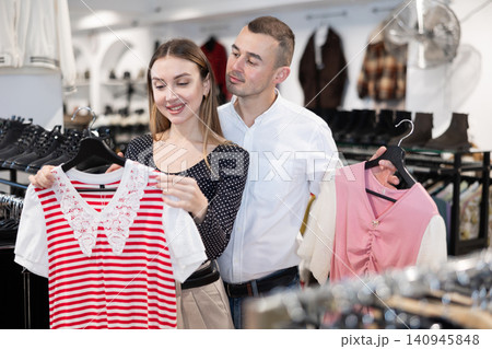 Couple young woman and young man choosing blouse Couple young woman and young man choosing blouse 140945848