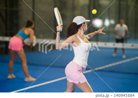 Two women playing tennis against man Two women playing tennis against man 140945884