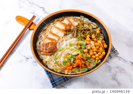guilin Style Rice Noodles topped with Crispy Roasted Pork Belly and Pickled Vegetables guilin Style Rice Noodles topped with Crispy Roasted Pork Belly and Pickled Vegetables 140946139