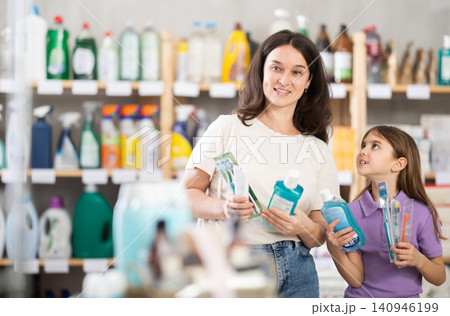 Woman with daughter choosing dental care products 140946199