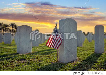 American national military cemetery with rows of white tomb stones and USA flag on green grass lawn. Memorial Day concept American national military cemetery with rows of white tomb stones and USA flag on green grass lawn. Memorial Day concept 140946267