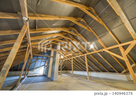 Attic of a building with wooden beams of a roof structure. Attic of a building with wooden beams of a roof structure. 140946378