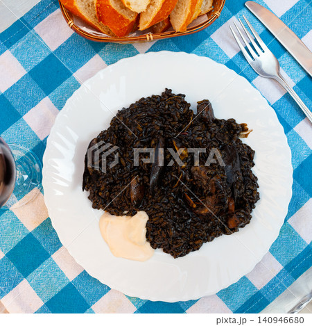 Arroz negro - spanish recipe, black paella with cuttlefish on plate 140946680
