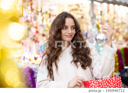 Woman choosing Christmas balls Woman choosing Christmas balls 140946712