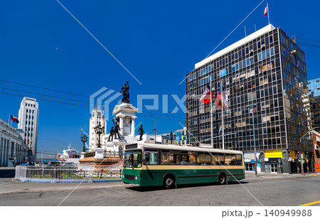 A vintage green trolleybus passes the Monument to the Heroes of Iquique at Plaza Sotomayor in Valparaiso, Chile. A vintage green trolleybus passes the Monument to the Heroes of Iquique at Plaza Sotomayor in Valparaiso, Chile. 140949988