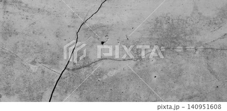 Weathered concrete wall texture with diagonal cracks and natural surface imperfections. 140951608