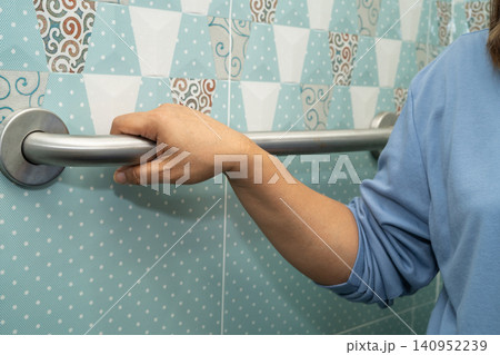 Asian elderly woman patient use toilet bathroom handle security in nursing hospital, healthy strong medical. Asian elderly woman patient use toilet bathroom handle security in nursing hospital, healthy strong medical. 140952239