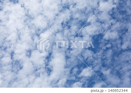 Blue sky with scattered white clouds Blue sky with scattered white clouds 140952344