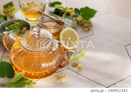 Linden herbal tea brewing with honey and lemon 140952381