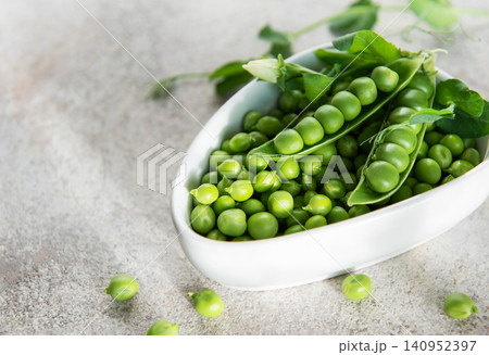 Fresh green peas in bowl representing healthy eating Fresh green peas in bowl representing healthy eating 140952397