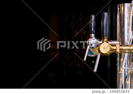 Beer drink faucets dispensers on black in bar Beer drink faucets dispensers on black in bar 140952635