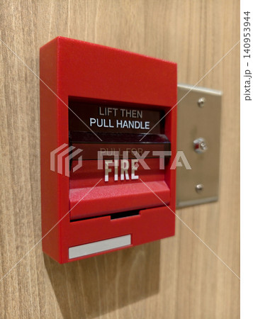 Fire alarm pull station on wooden wall Fire alarm pull station on wooden wall 140953944