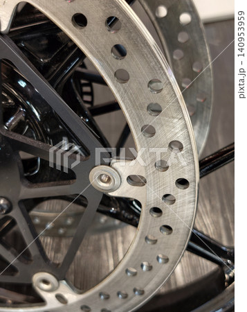Close-up of a metallic motorcycle disc brake and wheel Close-up of a metallic motorcycle disc brake and wheel 140953959