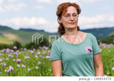 Authentic mature woman enjoying nature in a flowering countryside landscape 140954379