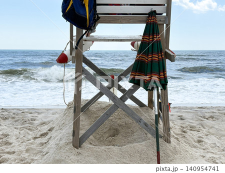 Looking Through a Lifeguard Stand on Sandy Beach Near Ocean Waves in Sunny Weather 140954741