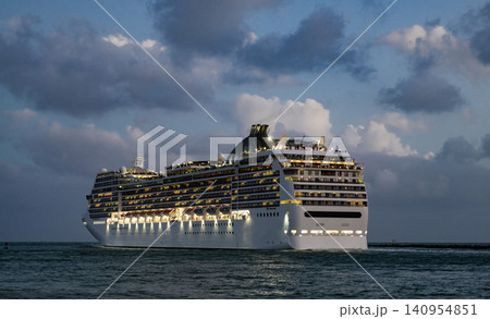 Cruise ship vacation. Bon voyage. Majestic cruise ship in vacation summer. Cruise ship vacation and travel at sea. View of illuminated luxury liner. Ship at night port. Luxury sea vacation Cruise ship vacation. Bon voyage. Majestic cruise ship in vacation summer. Cruise ship vacation and travel at sea. View of illuminated luxury liner. Ship at night port. Luxury sea vacation 140954851
