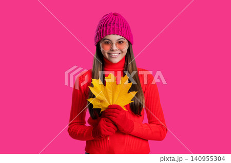 Stylish girl hold maple leaves. Fall season. Hello autumn. Carefree teen girl in hat and gloves isolated on pink. Autumn foliage. Autumn and leisure. Fall leaves and beautiful girl. Falling leaves 140955304