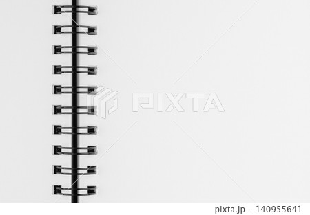 Close up of open spiral notebook blank white paper page with copy space Close up of open spiral notebook blank white paper page with copy space 140955641