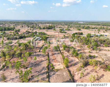 Patchwork farm fields and agricultural land in rural countryside. Cultivated plots, natural vegetation, and expansive horizon during the dry season. Sustainable agriculture and rural development. 140956877