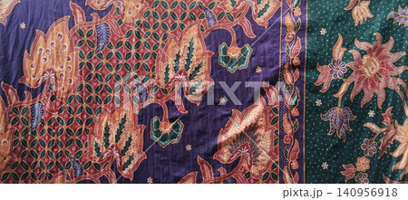 Traditional Indonesian batik fabric patterns featuring floral and geometric motifs. 140956918