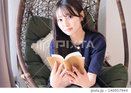 リビングのハンギングチェアでくつろぐ女性 リビングのハンギングチェアでくつろぐ女性 140957944