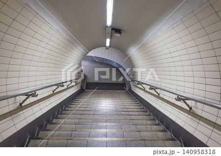 Empty tiled pedestrian tunnel with stairs in a subway station Empty tiled pedestrian tunnel with stairs in a subway station 140958318