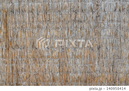 Building a wall with straw and twigs in rural area 140958414