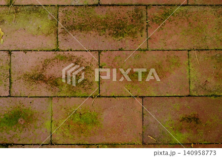 Mossy Red Brick Pavement Texture Background Weathered Clay Cobblestone Surface Mossy Red Brick Pavement Texture Background Weathered Clay Cobblestone Surface 140958773