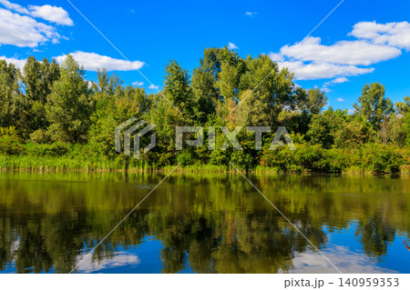 Summer landscape with beautiful river, green trees and blue sky 140959353