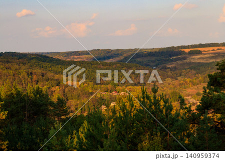 Picturesque autumn scenery with blue sky and colorful autumn trees on mountain hills Picturesque autumn scenery with blue sky and colorful autumn trees on mountain hills 140959374