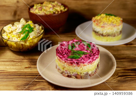 Set of festive mayonnaise salads on wooden table Set of festive mayonnaise salads on wooden table 140959386