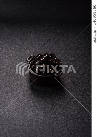 Black canned olives without pits for salads and snacks. Black olives without pits Black canned olives without pits for salads and snacks. Black olives without pits 140959560