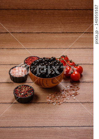 Black canned olives without pits for salads and snacks. Black olives without pits Black canned olives without pits for salads and snacks. Black olives without pits 140959587