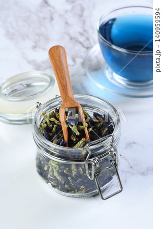 Blue butterfly pea tea in a glass jar and cup on marble background Blue butterfly pea tea in a glass jar and cup on marble background 140959594